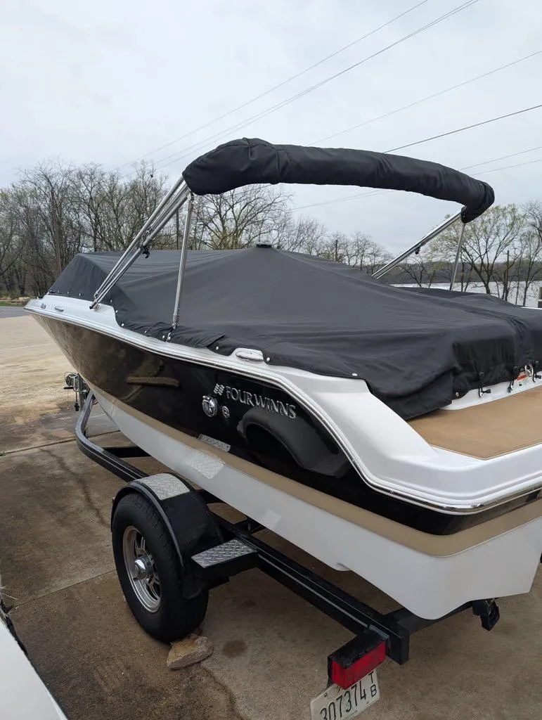 Slide: The Image of 2016 Four Winns 180 Horizon boat on trailer, covered and parked outdoors. - 6