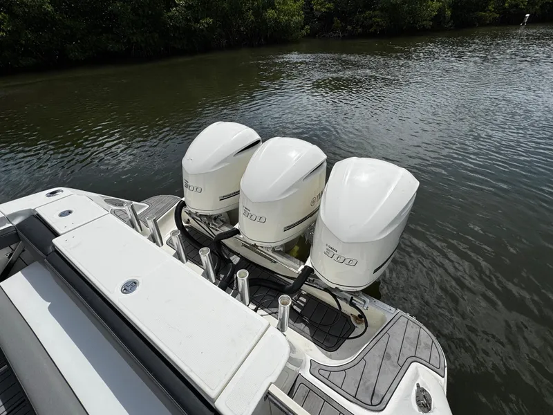 Slide: The Image of 2005 Hydra-Sports 3300 VX boat with triple outboard engines on a calm waterway. - 10