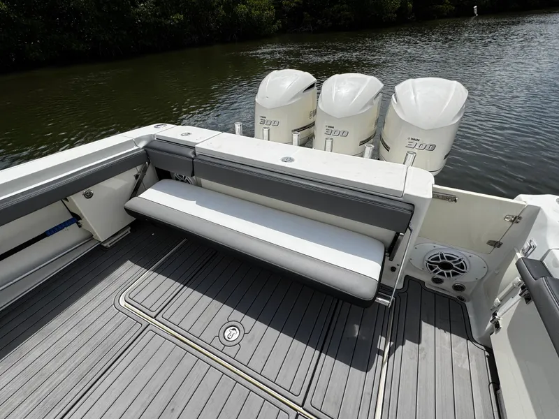 Slide: The Image of 2005 Hydra-Sports 3300 VX boat with triple outboard engines and spacious seating area. - 11