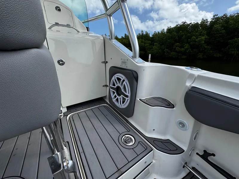 Slide: The Image of 2005 Hydra-Sports 3300 VX boat interior with seating and speaker, under a cloudy sky. - 14
