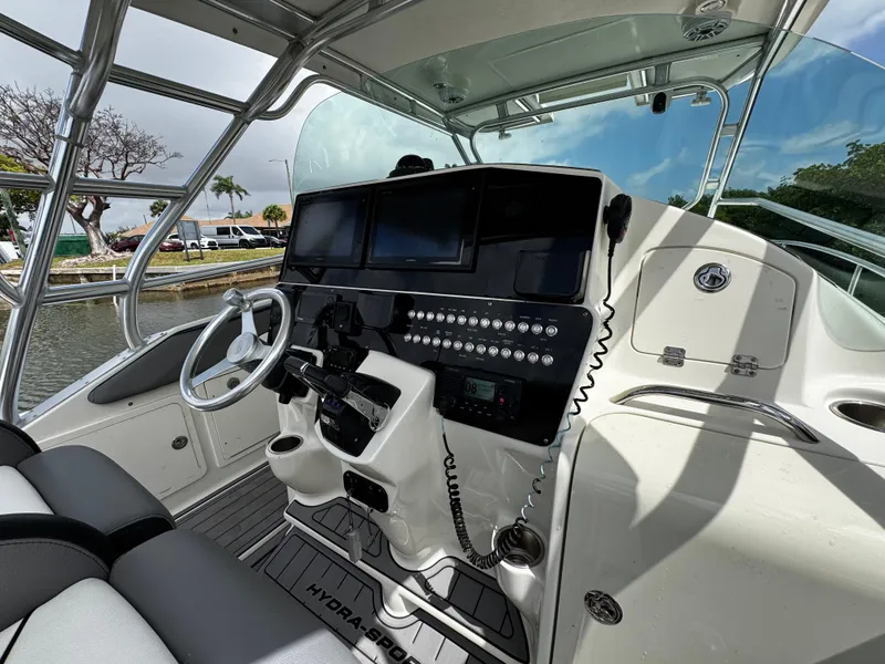 Slide: The Image of 2005 Hydra-Sports 3300 VX boat cockpit with modern controls and steering wheel. - 16
