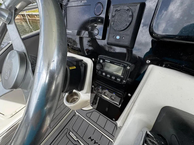 Slide: The Image of 2005 Hydra-Sports 3300 VX boat dashboard with steering wheel and control panel. - 19