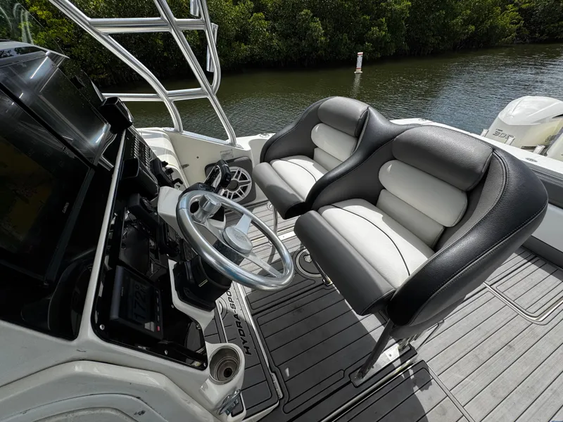 Slide: The Image of 2005 Hydra-Sports 3300 VX boat cockpit with dual seats and steering wheel. - 20