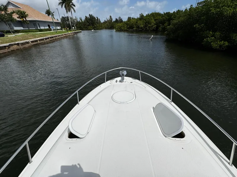 Slide: The Image of 2005 Hydra-Sports 3300 VX boat cruising on a calm river with lush greenery. - 22