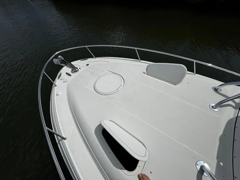 Slide: The Image of 2005 Hydra-Sports 3300 VX boat deck with open hatches on calm water. - 23
