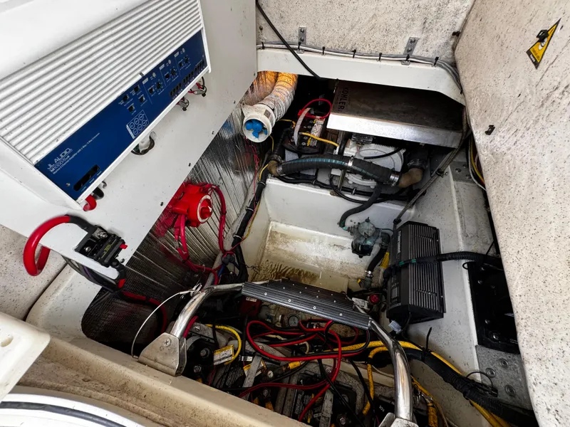 Slide: The Image of Engine compartment of a 2005 Hydra-Sports 3300 VX boat, showcasing wiring and components. - 24
