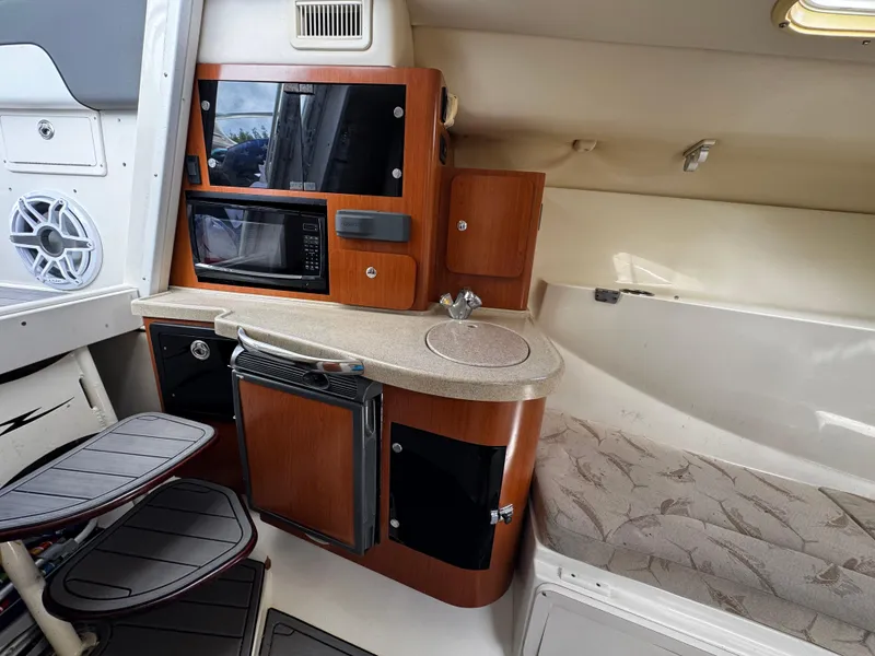 Slide: The Image of 2005 Hydra-Sports 3300 VX cabin interior with kitchenette and seating area. - 27