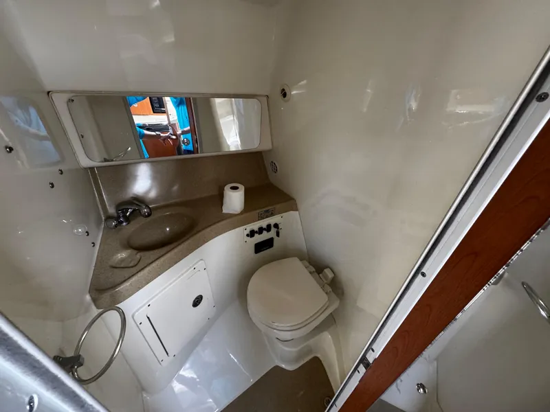Slide: The Image of 2005 Hydra-Sports 3300 VX boat bathroom with sink, toilet, and mirror. - 29