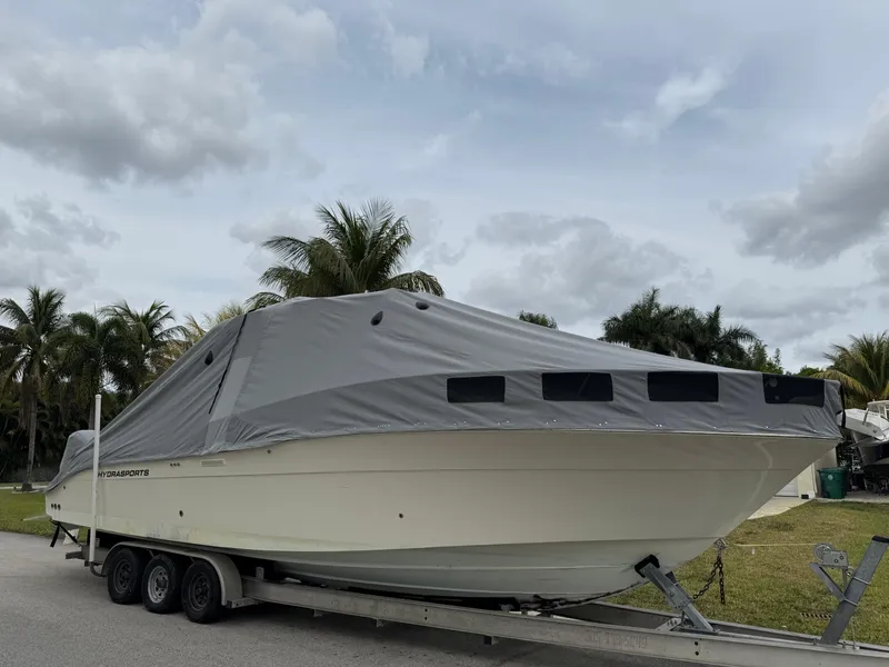 Slide: The Image of 2005 Hydra-Sports 3300 VX boat on trailer, covered, with palm trees in background. - 32
