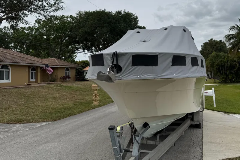 Slide: The Image of 2005 Hydra-Sports 3300 VX boat covered on trailer in residential driveway. - 36