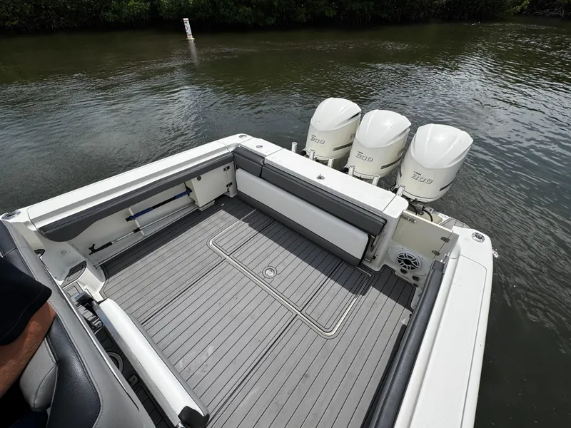 Slide: The Image of 2005 Hydra-Sports 3300 VX boat with triple outboard engines on calm water. - 8