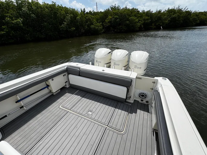 Slide: The Image of 2005 Hydra-Sports 3300 VX boat with triple engines on a calm river. - 9