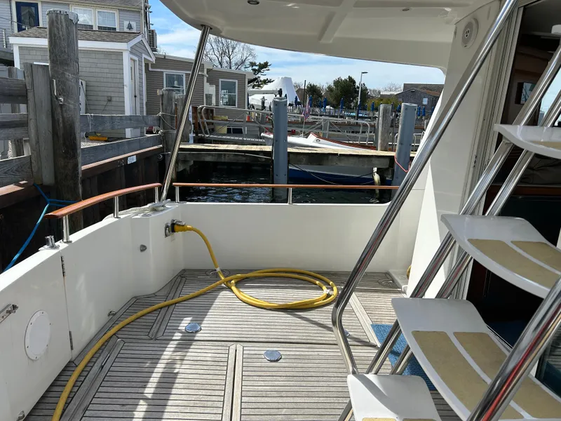 Slide: The Image of 2006 Beneteau 42 Swift Trawler deck with dock view and coiled hose. - 2