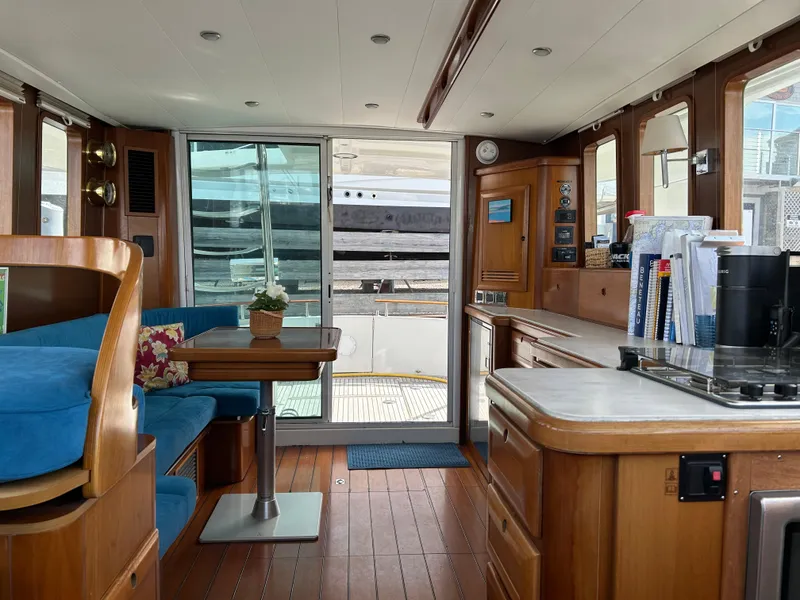 Slide: The Image of Interior of 2006 Beneteau 42 Swift Trawler with wood finish and blue seating. - 21