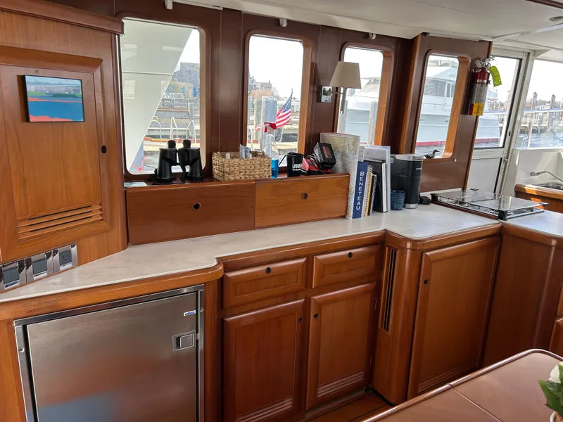 Slide: The Image of Interior of 2006 Beneteau 42 Swift Trawler with wooden cabinetry and modern appliances. - 26