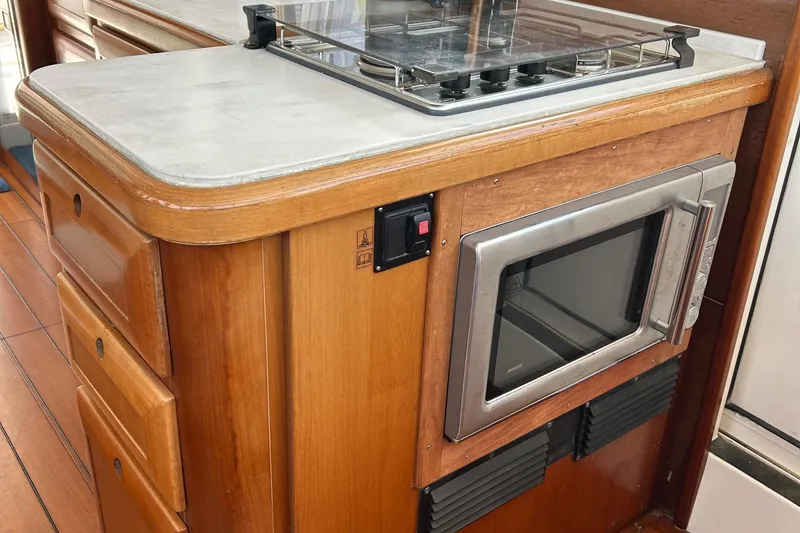 Slide: The Image of Kitchen area of 2006 Beneteau 42 Swift Trawler with microwave and stove. - 28