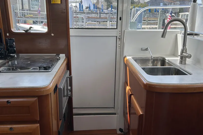 Slide: The Image of Interior of 2006 Beneteau 42 Swift Trawler kitchen with sink and stove. - 29