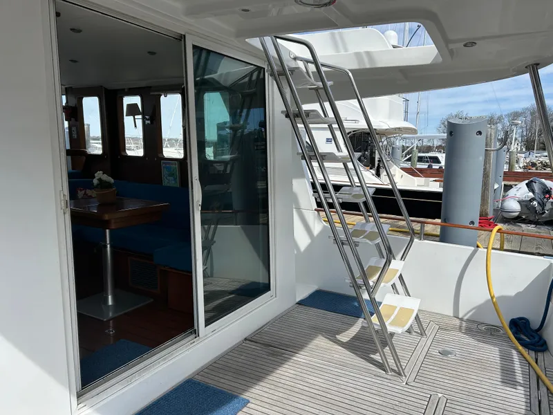 Slide: The Image of 2006 Beneteau 42 Swift Trawler deck with ladder and sliding glass door. - 3