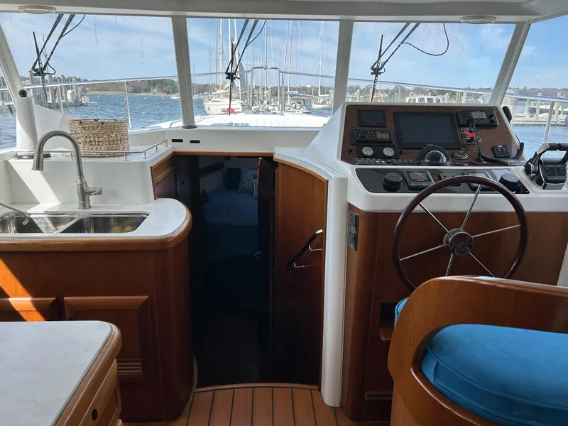 Slide: The Image of Interior view of 2006 Beneteau 42 Swift Trawler with helm, sink, and wooden finishes. - 31