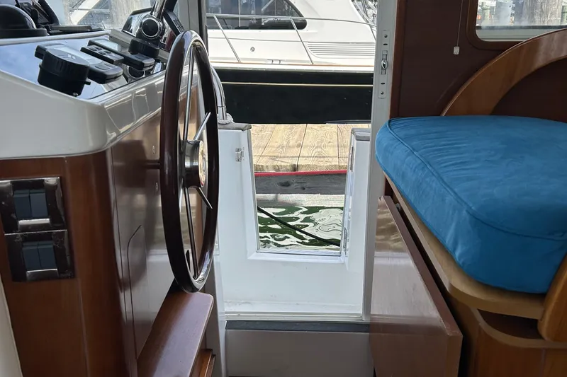Slide: The Image of Interior view of 2006 Beneteau 42 Swift Trawler with helm and seating area. - 33