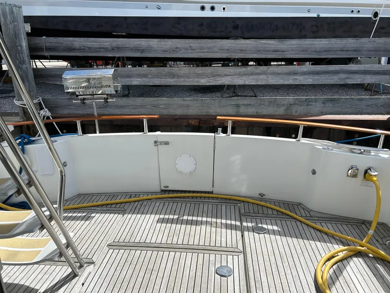 Slide: The Image of Beneteau 42 Swift Trawler 2006 deck with wooden flooring and railing. - 4