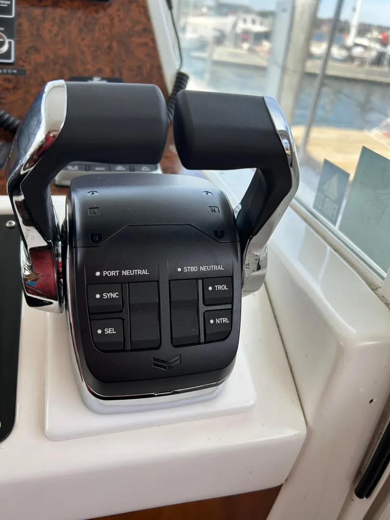 Slide: The Image of Throttle controls on a 2006 Beneteau 42 Swift Trawler, featuring dual levers and control buttons. - 40