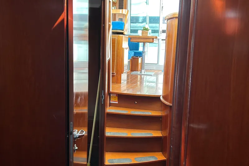 Slide: The Image of Interior view of 2006 Beneteau 42 Swift Trawler with wooden stairs and seating area. - 41