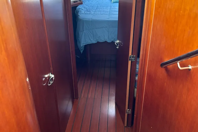 Slide: The Image of Interior hallway of 2006 Beneteau 42 Swift Trawler with wood paneling and visible bedroom. - 42