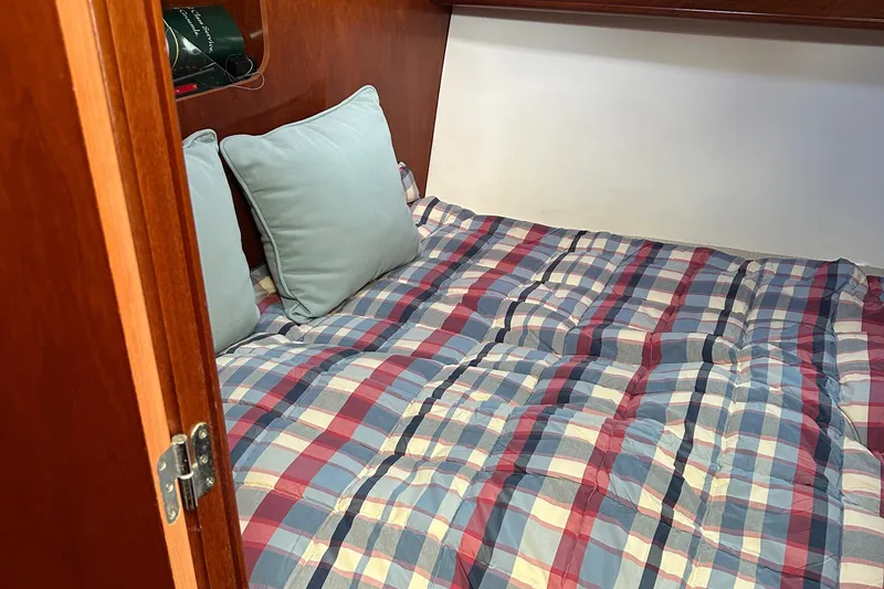 Slide: The Image of Cozy cabin bed with plaid bedding in 2006 Beneteau 42 Swift Trawler. - 43