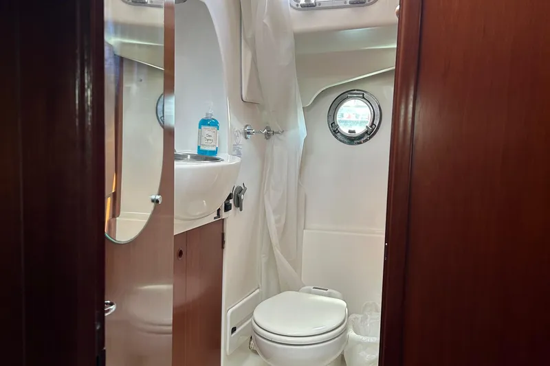 Slide: The Image of Bathroom interior of 2006 Beneteau 42 Swift Trawler with porthole and sink. - 45