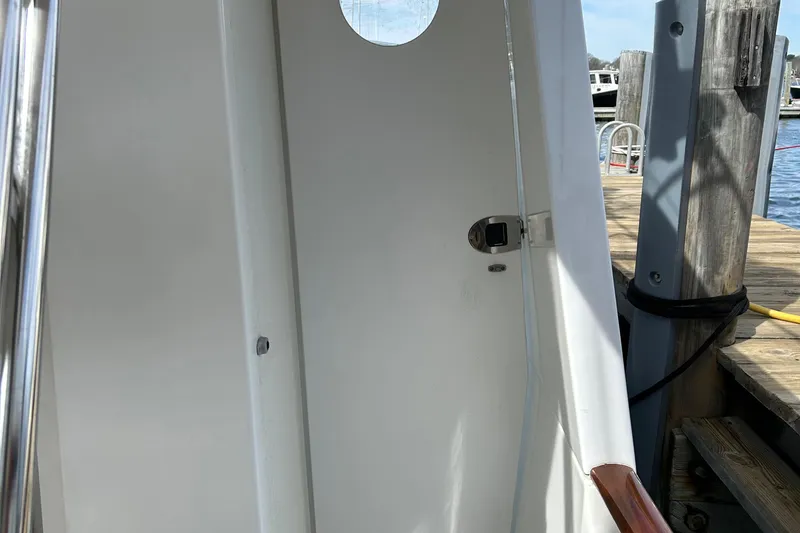 Slide: The Image of Beneteau 42 Swift Trawler 2006, white exterior with porthole, docked at marina. - 7