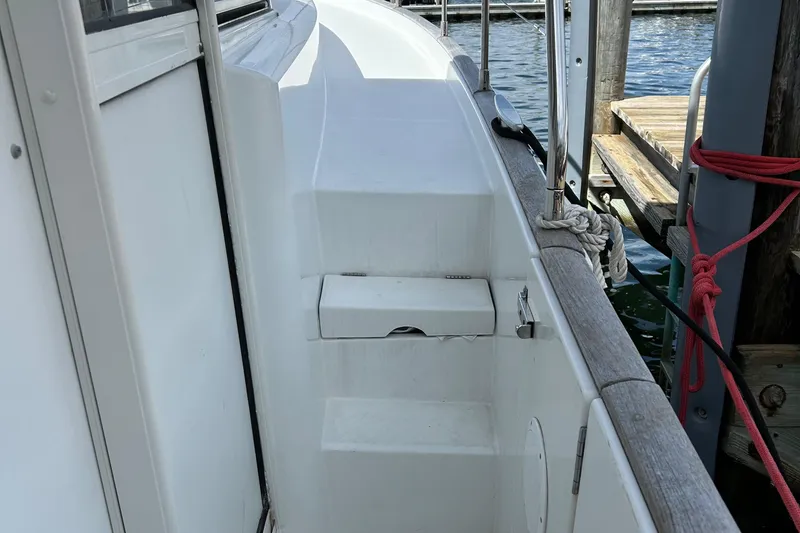 Slide: The Image of Side deck of 2006 Beneteau 42 Swift Trawler at dock, showing steps and railing. - 8