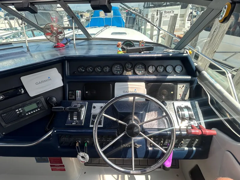 Slide: The Image of Cockpit of 1990 Sea Ray 350 Sundancer with Garmin navigation system and steering wheel. - 14