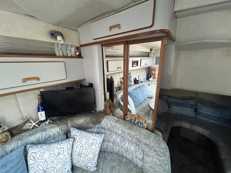 Slide: The Image of Interior of 1990 Sea Ray 350 Sundancer with cozy seating and modern amenities. - 20