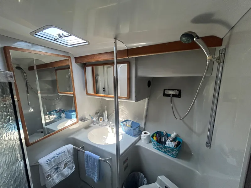 Slide: The Image of Bathroom interior of a 1990 Sea Ray 350 Sundancer yacht with shower and sink. - 27
