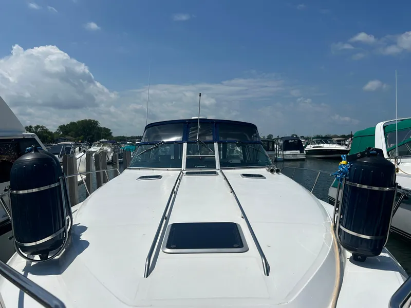 Slide: The Image of 1990 Sea Ray 350 Sundancer yacht docked under a clear blue sky. - 3