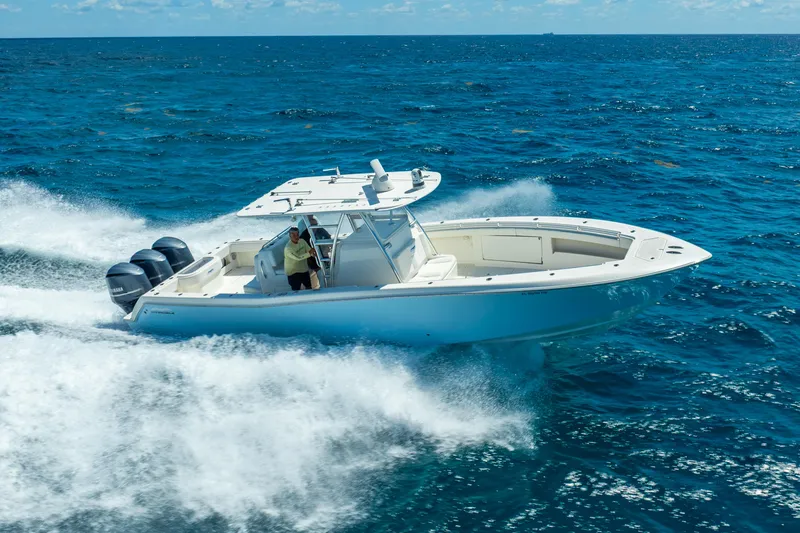 Slide: The Image of Invincible 39 boat cruising on open ocean, 2016 model, with triple outboard engines. - 1