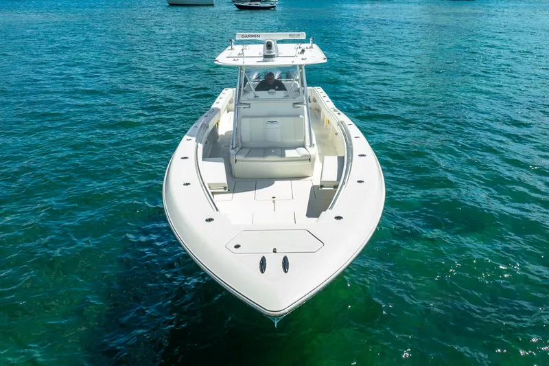 Slide: The Image of 2016 Invincible 39 boat on clear blue water, viewed from the front. - 11