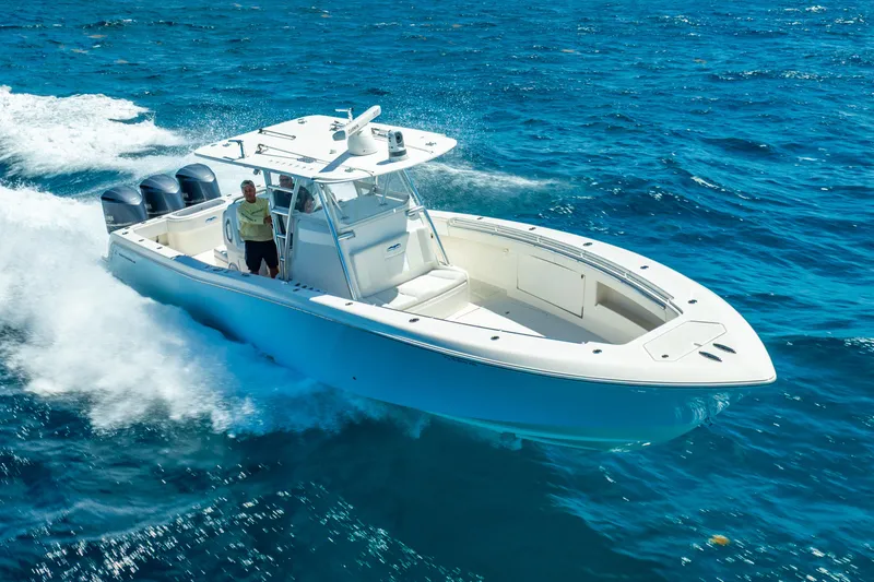 Slide: The Image of 2016 Invincible 39 boat cruising on open blue water. - 12