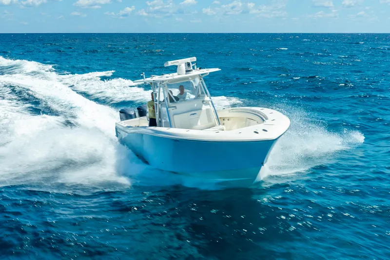 Slide: The Image of Invincible 39 boat cruising on open ocean, 2016 model, creating waves. - 13