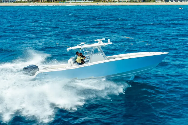 Slide: The Image of 2016 Invincible 39 boat cruising swiftly on open blue ocean waters. - 15