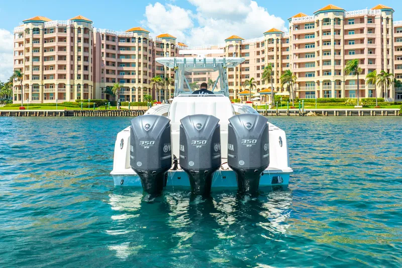 Slide: The Image of Invincible 39 boat with triple engines on water, luxury buildings in background, 2016 model. - 21