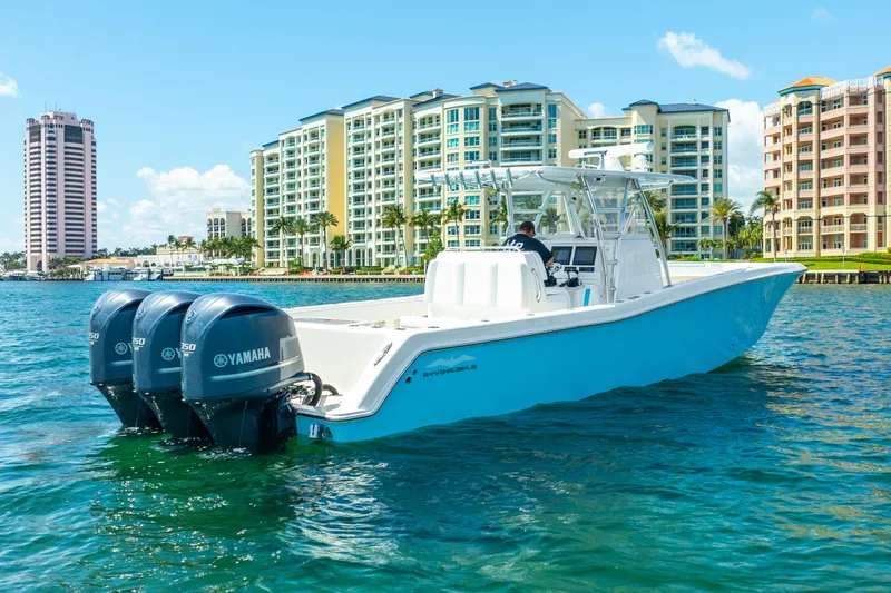 Slide: The Image of 2016 Invincible 39 boat with Yamaha engines on water, cityscape background. - 22