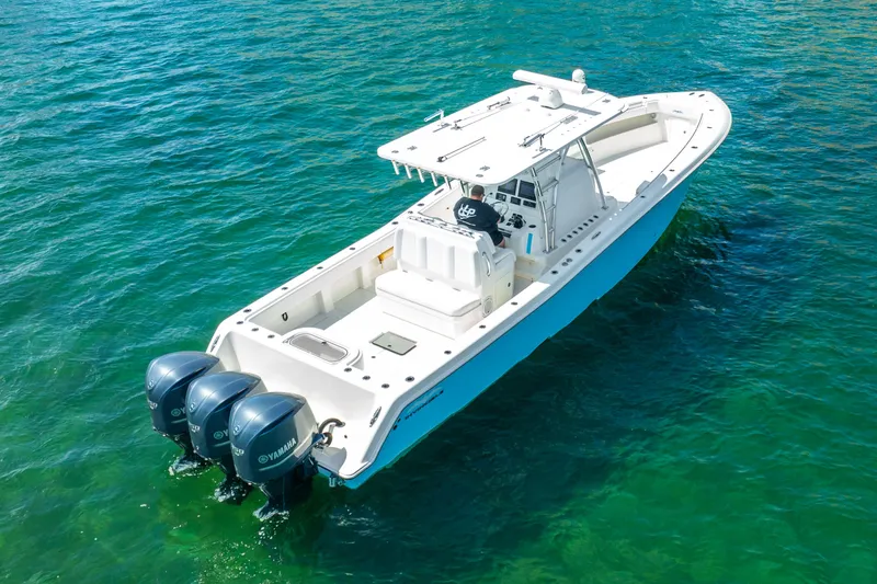 Slide: The Image of 2016 Invincible 39 boat with triple Yamaha engines on clear water. - 23