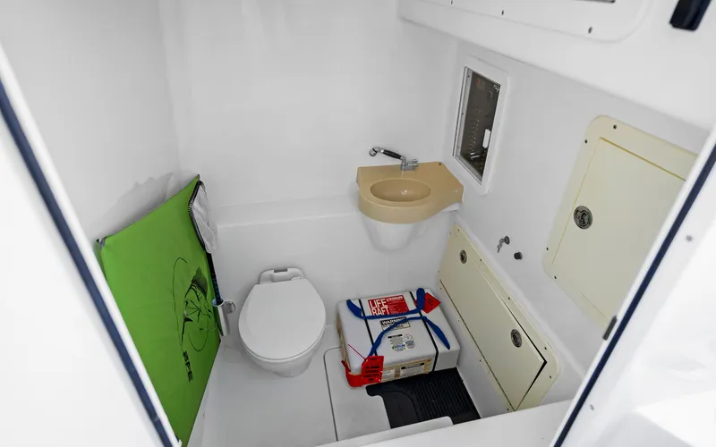Slide: The Image of Compact boat bathroom with toilet, sink, and storage in 2016 Invincible 39 model. - 27