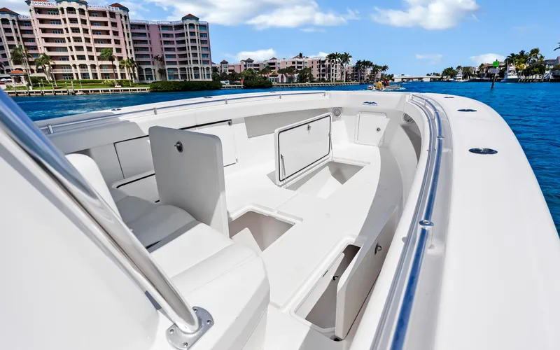 Slide: The Image of 2016 Invincible 39 boat with spacious deck, docked near waterfront buildings. - 30