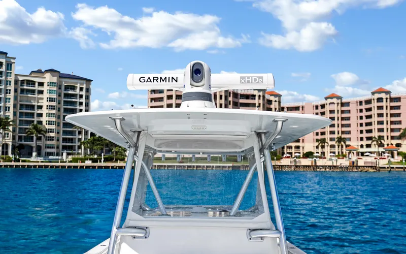 Slide: The Image of Invincible 39 boat with Garmin radar, 2016 model, docked near waterfront buildings. - 32