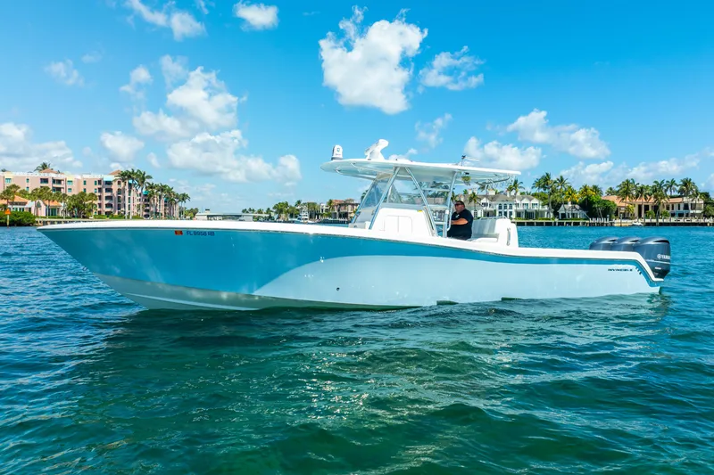 Slide: The Image of 2016 Invincible 39 boat cruising on clear blue water under a sunny sky. - 4