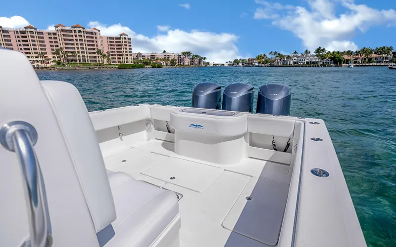 Slide: The Image of 2016 Invincible 39 boat on water, with cityscape and palm trees in background. - 42