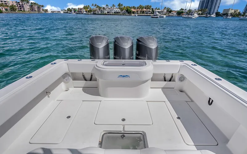 Slide: The Image of 2016 Invincible 39 boat deck with triple outboard motors on a sunny day. - 43